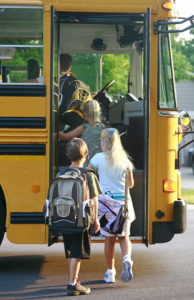 Students bording a school bus
